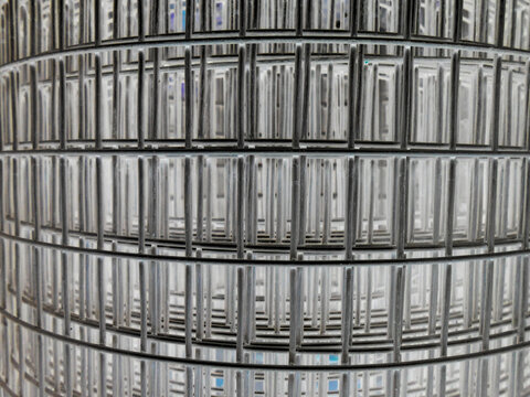 The metal reinforcing fine mesh is rolled up and prepared for operation. The photo was taken with the color inversion effect.