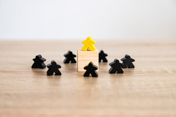Yellow figure on cube surrounded by black shapes