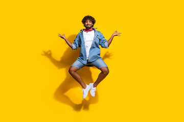 Fototapeta na wymiar Full length photo of handsome young guy jump yoga meditate om wear trendy denim garment red scarf isolated on yellow color background