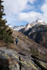 Naklejka na ściany i meble Hiker walking on the path in Pyrenees mountains near Gavarnie, High quality photo