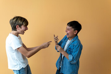 Two children facing each other laughing their heads off