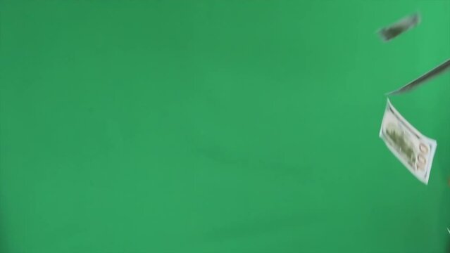 Flowing 100 dollar bills American currency on vibrant green screen background. Wealth and money concept. Attract potential investors.