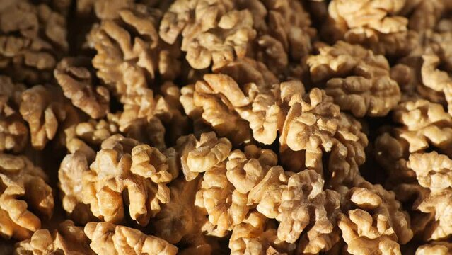 Walnut kernels rotating. walnut close up lies under beams of the sun. Walnut close up. product rich in minerals and vitamins. Macro 4K