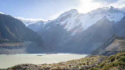 Alpine glacial landscape with huge mountains and lake on a sunny day, Mt Cook, New Zealand