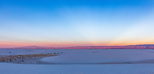 Mountains are glowing near sunset at White Sands NP.