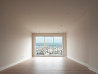 New apartment, empty, ready to move in. Interior view of the living room looking towards the window