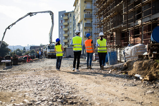 Four construction workers having meeting.