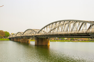 Fototapeta na wymiar Truong Tien Bridge Crossing Huong River In Hue City, Vietnam. Truong Tien Bridge Is One Of The Symbols Of Hue City.