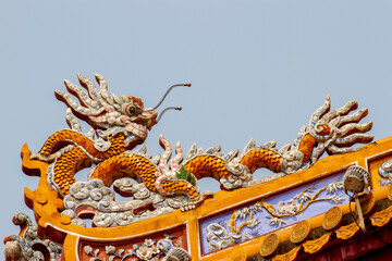 Fototapeta premium Detail Of Ceramic Dragon On The Roof Of A Palace In Hue Imperial Citadel, Vietnam.