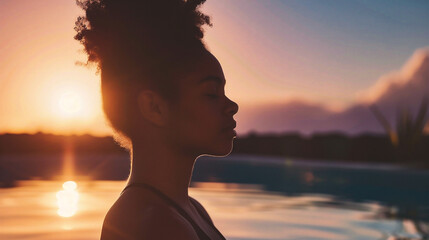 Side view of young african american woman at sunset - obrazy, fototapety, plakaty