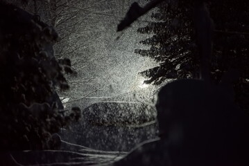 Russia. Kuznetsk Alatau. A night snowfall illuminated by lanterns in a mountain taiga village far...