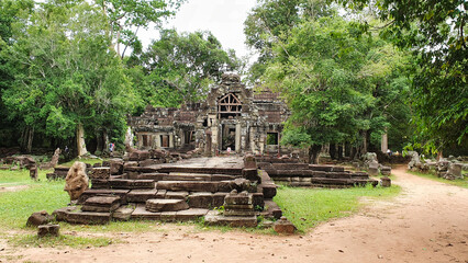 Outer gate of Ta Phrom - Iconic 12th century Angkor Khmer Temple with Tree roots intertwined with the temple structure, famous for Tomb Raider movie featuring Angeline Jolie at Siem Reap, Cambodia