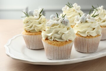 Tasty Easter cupcakes with vanilla cream on wooden table, closeup