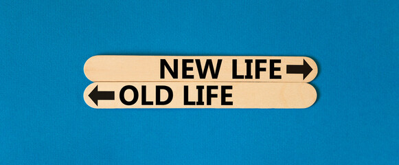New or old life symbol. Concept word New life Old life on beautiful wooden stick. Beautiful blue...