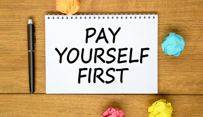 Pay yourself first symbol. Concept words Pay yourself first on beautiful white note. Beautiful wooden background. Black pen. Colored paper. Business and pay yourself first concept. Copy space.