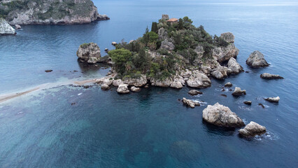 Panoramic view of beautiful Isola Bella, small island near Taormina, Sicily, Italy. Narrow path connects island to mainland Taormina beach surrounded by azure waters of Ionian Sea. - 770872813