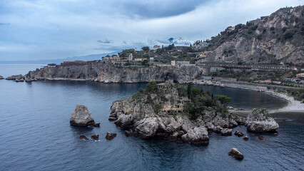 Panoramic view of beautiful Isola Bella, small island near Taormina, Sicily, Italy. Narrow path connects island to mainland Taormina beach surrounded by azure waters of Ionian Sea. - 770873021