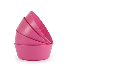 Set of reusable pink plastic bowls, colourful, graphic prawn shape, isolated on white background. Concept of fun children’s food, eco-friendly parties and picnics, reusable tableware.