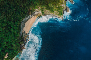 Landscape with hidden beach and blue ocean with waves in Indonesia. Aerial view. - 770876248