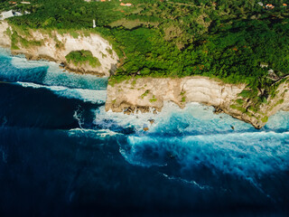 Aerial view of coastline with cliffs, ocean with waves and lighthouse - 770876817