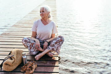 Senior woman relaxing on bridge.