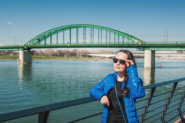 Beautiful woman with sunglasses against bridge in Belgrade, Serbia