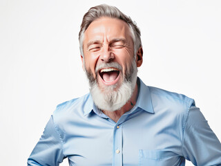 An elderly man in a blue shirt with a beard laughs loudly , white background