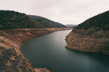 Mansilla reservoir full shot eye level  in a cloudy day half full cinematic