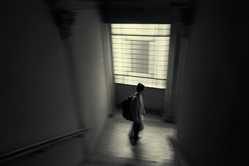 silhouette of a person in a blurry corridor in Lucca italy - obrazy, fototapety, plakaty