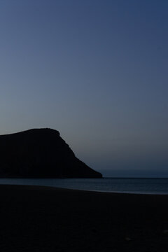 la Tejita beach sunrise in blue hour with the silhouette of the hill, the sand  and the ocean