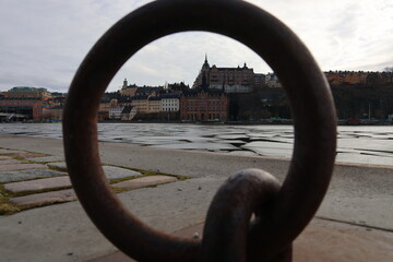 A really cool picture of Stockholm through an anchorage on a quay. The round bracket provides a...