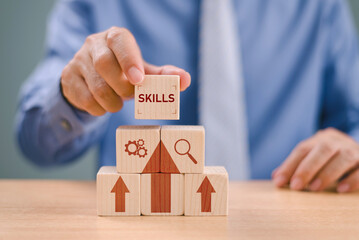 Skill development concept. Up new ability skill for technology evolution. Employee thinking, digital upskill. Businessman hand hold wooden cube with digital skill icon on white background, copy space