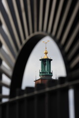 Obraz premium Artistic photo of Stockholm City Hall's tower with the three golden crowns that are an important Swedish symbol. 