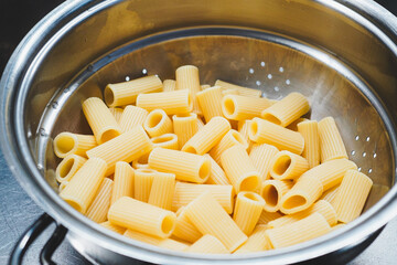 Cooked maccheroni pasta, drained in a colander