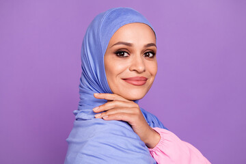 Profile photo of pretty young lady hand face wearing blue hijab isolated over purple color background