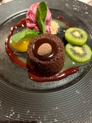 Chocolate cake with strawberry ice cream and fruits