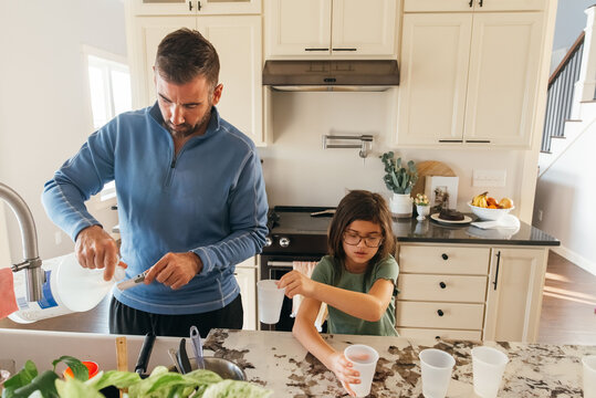 Girl giving helping hands to her Dad. 
