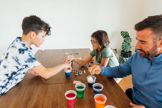 Family sitting at a dining room table. 