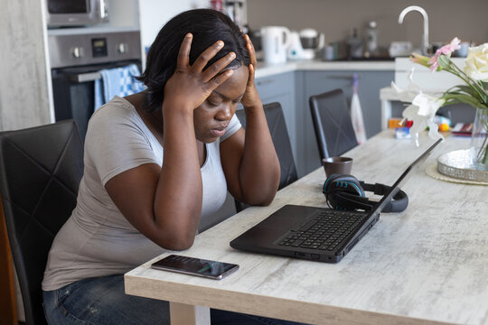 tired overwhelmed woman with laptop computer at home