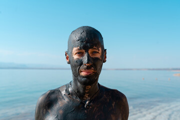 Man with Mud Mask at Lakeside