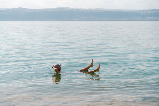 Man floating in the Dead Sea, travel Jordan                           