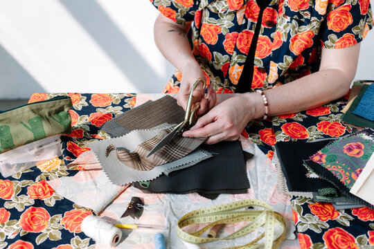 Closeup of Anonymous Pattern Cut Fabric Tailoring and Sewing
