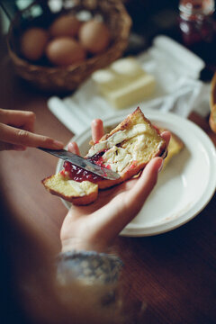  Spreading jam on the bread with butter