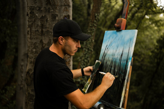 Young male artist creating art in nature