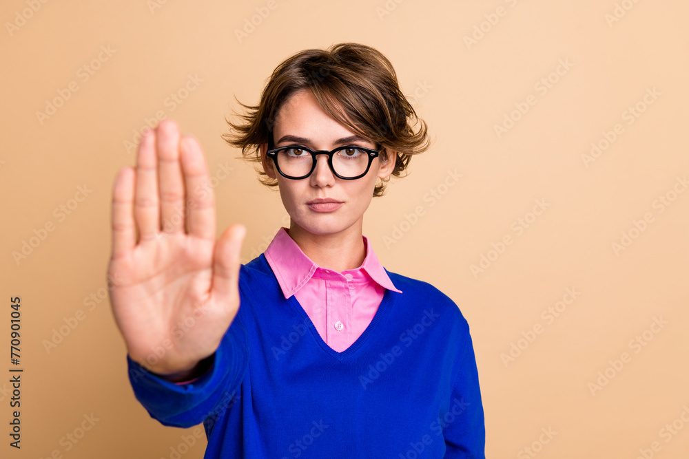 Sticker Photo of serious confident lady arm palm demonstrate stop symbol empty space isolated on beige color background