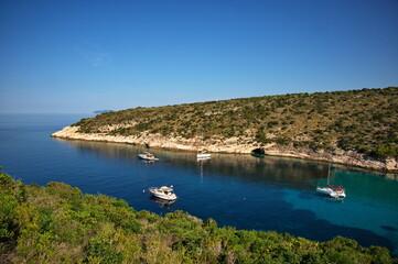 Fototapeta na wymiar Deep bay in Adriatic sea with sailboats anchored in clear blue water