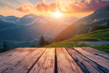 An empty wooden table overlooks a breathtaking alpine landscape at sunset - obrazy, fototapety, plakaty