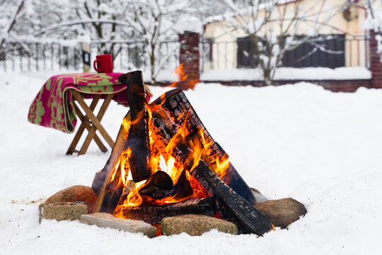Twilight campfire burning in cold winter evening