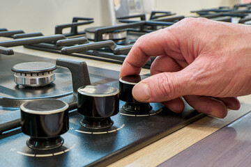 Gas stove. Turning on and off the gas burner. A home appliance store. Consumer