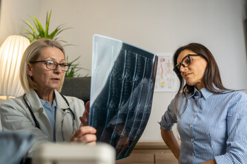 Female doctor diagnose spine lumbar spine MRI for diagnose Herniated disc disease with radiologic...